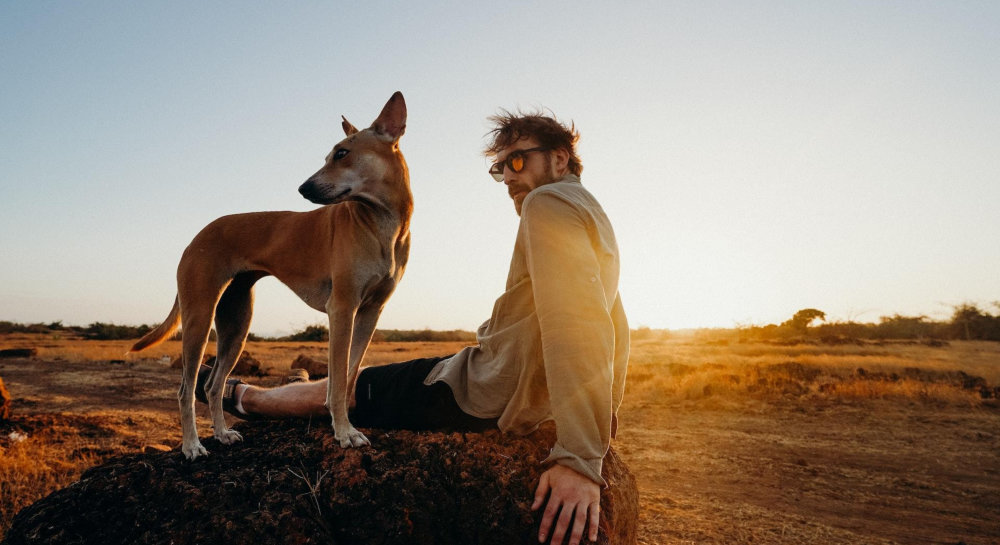 a man spending time outdoors with his pet dog